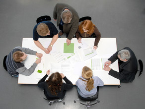 five students and a professor sitting aroung a table